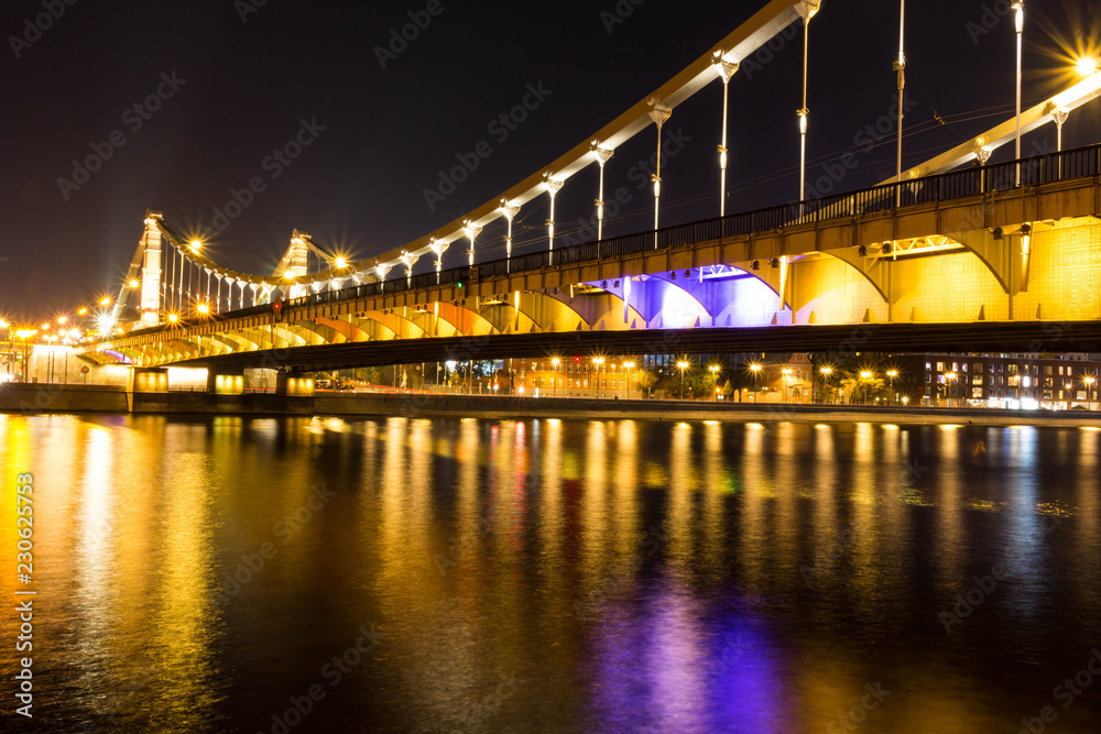Obraz premium The long beautiful bridge across the river in the evening.