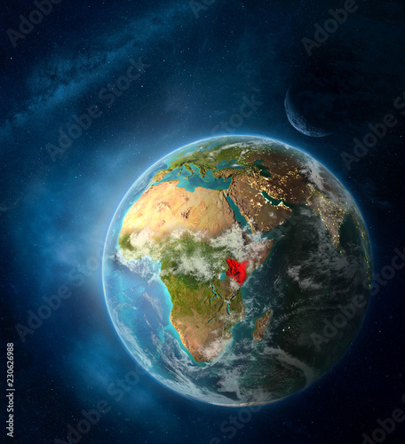 Fototapeta Naklejka Na Ścianę i Meble -  Kenya from space on Earth surrounded by space with Moon and Milky Way. Detailed planet surface with city lights and clouds.