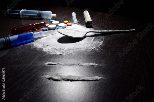 drugs concept , cocaine,injection,table,spoon on dark table. photo