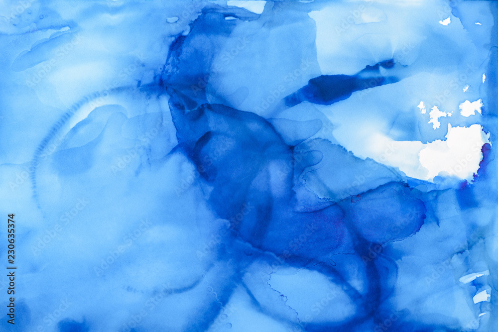 blue splashes of alcohol ink as abstract background