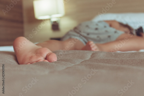 Close up of child sleeping on the bed.