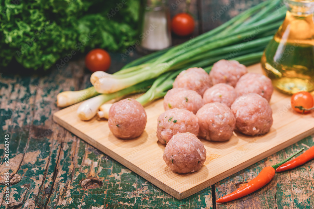 Homemade food. Raw fish ball (uncooked) in the kitchen with vegetables Homemade food. Raw fish ball (uncooked) in the kitchen with vegetables