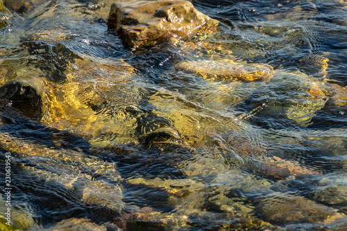 Sea stones and rocks of different sizes and texsture of black, gray and brown under the water on the Black Sea coast as nature bacground. Excellent concept for any design