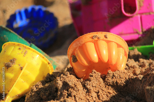 colorful toys for childrens sandboxes against the sea and the beach photo