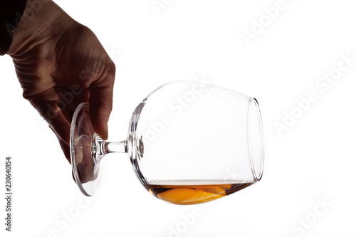 Hand holding a glass of cognac horisontal