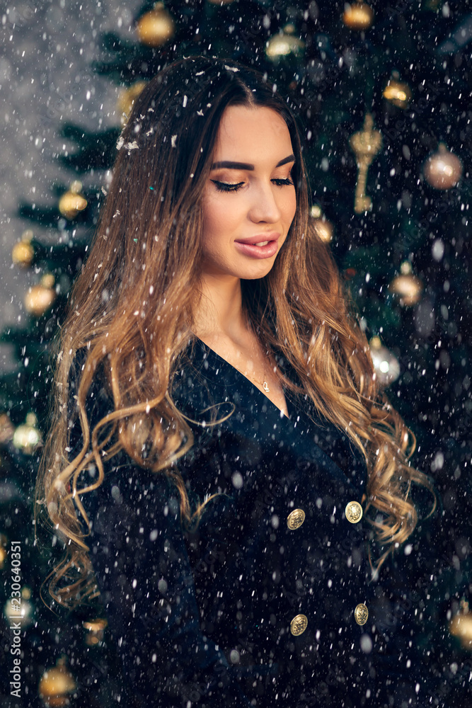Snow portrait of a beautiful young woman on new year's eve Snow portrait of a beautiful young woman on new year's eve