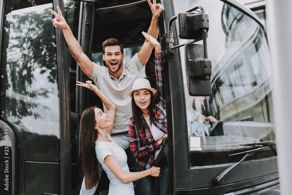 Young Smiling People Traveling on Tourist Bus