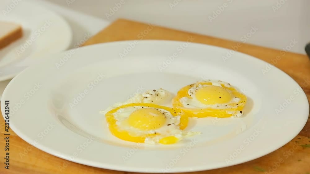 Fried eggs shaped with pepper slices on a plate Fried eggs shaped with pepper slices on a plate