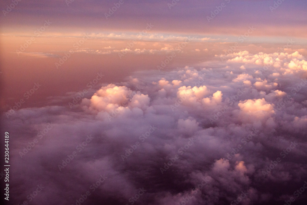 Flying above the clouds at sunset