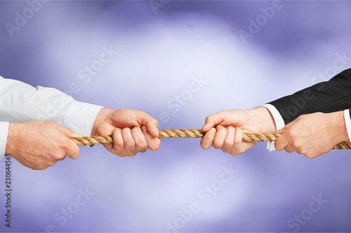 Business men hands holding rope on grey