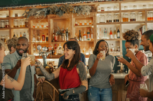 Diverse group of people drinking together in a trendy bar