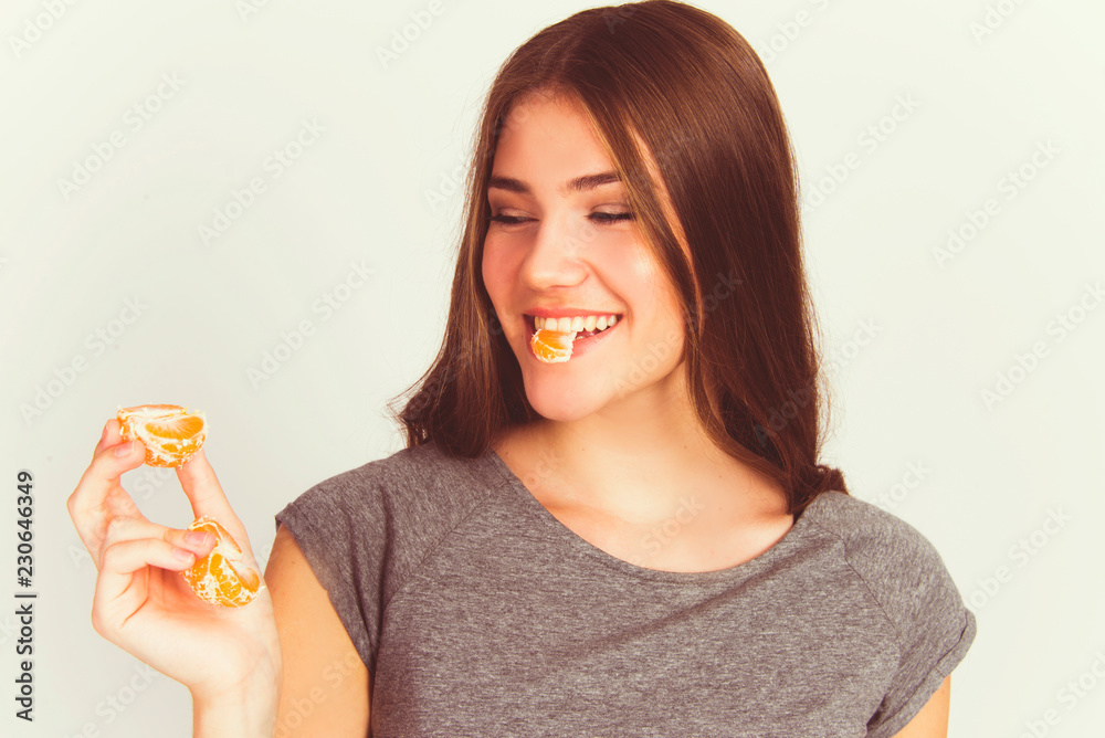 beautiful young woman eating mandarin vitamin c orange fruit