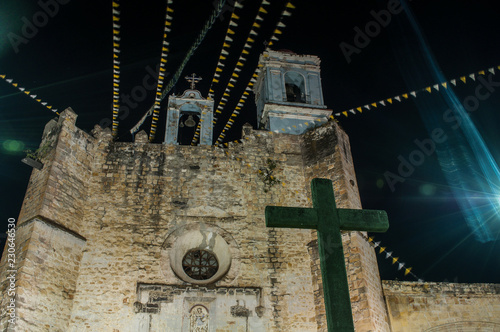 iglesia de huaquechula puebla mexico, vista nocturna y atardecer, entre nubes cruz en contraste photo