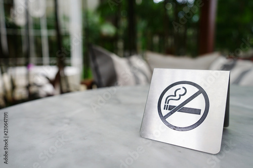No smoking sign made of stainless on marble table