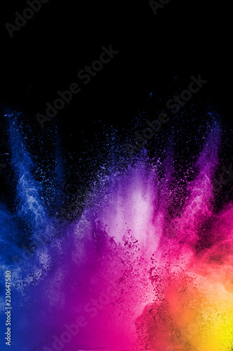 color powder explosion cloud on black background. Freeze motion of color dust  particles splashing.