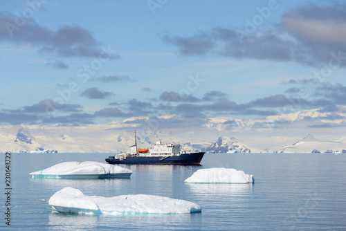 Expedition ship with iceberg in Antarctic sea