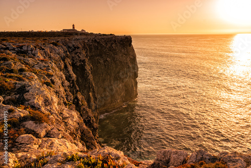 Rugged cliffs of the coastline of Cape St. Vincent at sunset.  Near Lagos, Algarve region of Portugal.