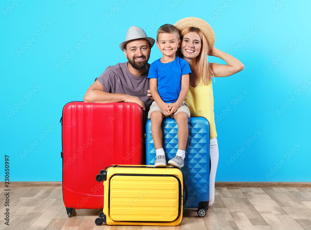 Happy family with suitcases near color wall. Vacation travel Happy family with suitcases near color wall. Vacation travel
