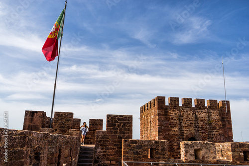 Woman posing in the Silves Castle. A medieval fortress built by the Moorish empire/caliphate, Algarve region of Portugal.