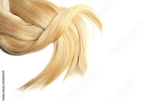 Locks of healthy blond hair on white background