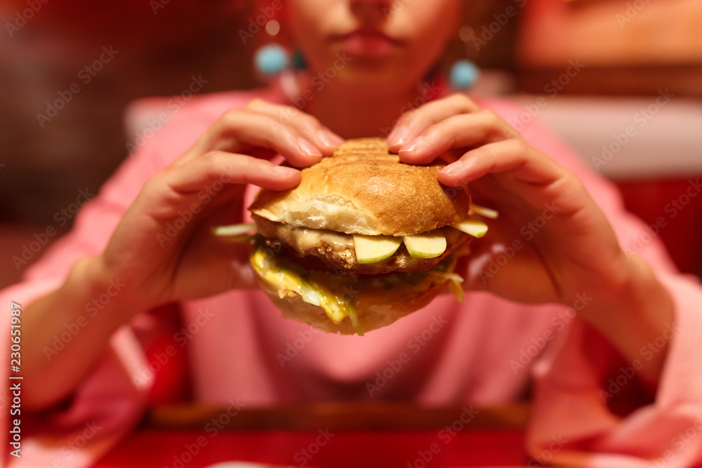 Hamburger in the hands of a girl