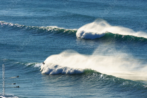 waves spraying and surfers on the sea