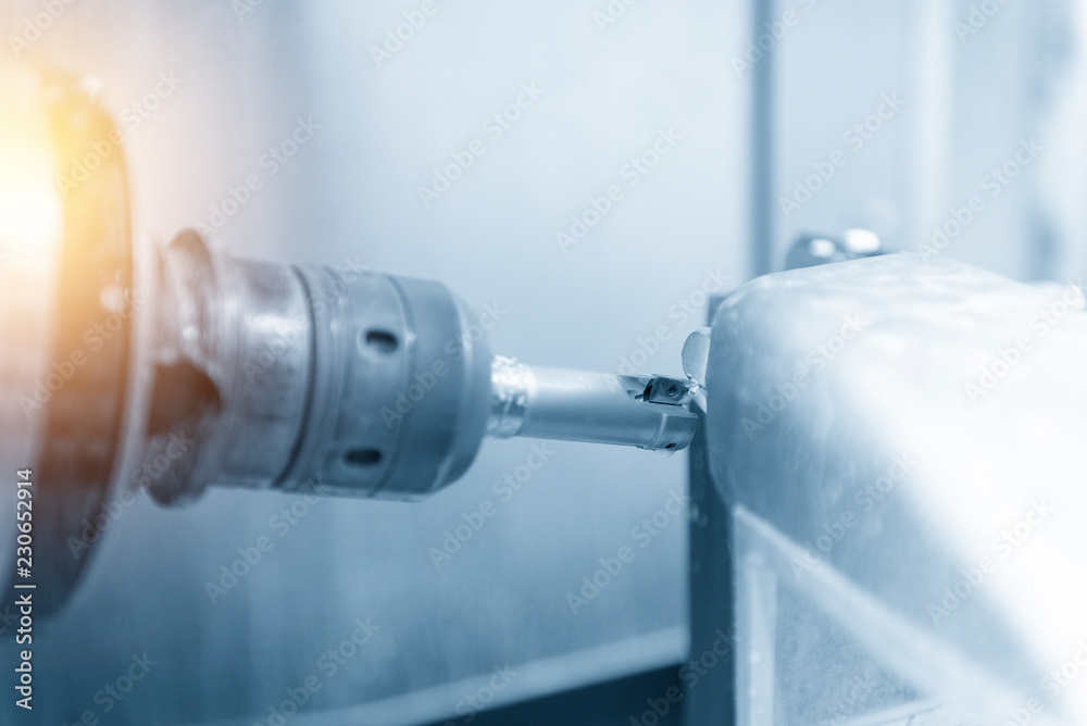 The 5-axis CNC milling machine or machining center cutting the automotive part with the solid ball endmill tool in the light blue scene.The Hi-Technology manufacturing process.