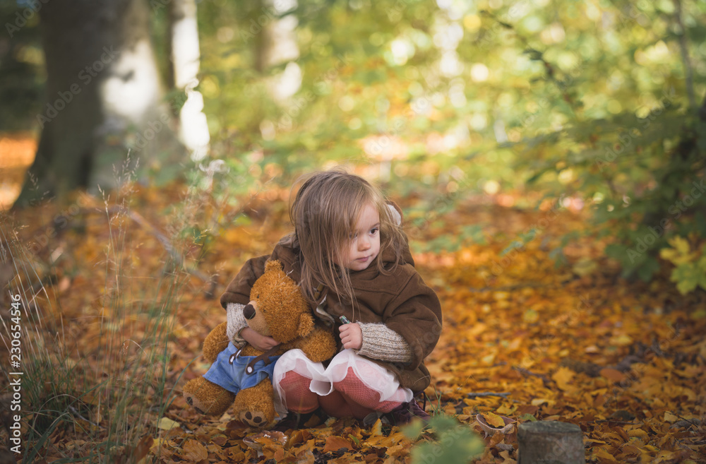 Fairy Girl Playing wiht Teddy Bear in Woods.Beautiful little girl in autumn forest Fairy Girl Playing wiht Teddy Bear in Woods.Beautiful little girl in autumn forest