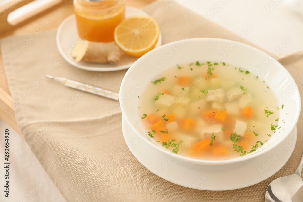 Bowl of fresh homemade soup to cure flu on tray