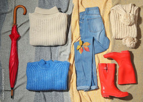Set of stylish winter outfit on blanket, flat lay