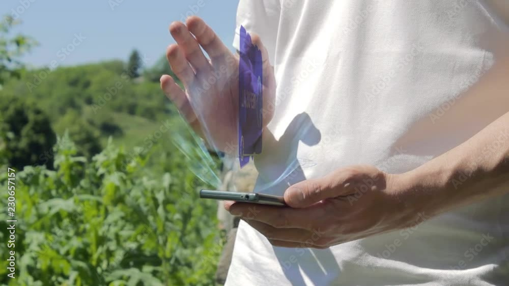 Man shows concept hologram Refusal on his phone. Person in white t-shirt with future technology holographic screen and green nature background Man shows concept hologram Refusal on his phone. Person in white t-shirt with future technology holographic screen and green nature background