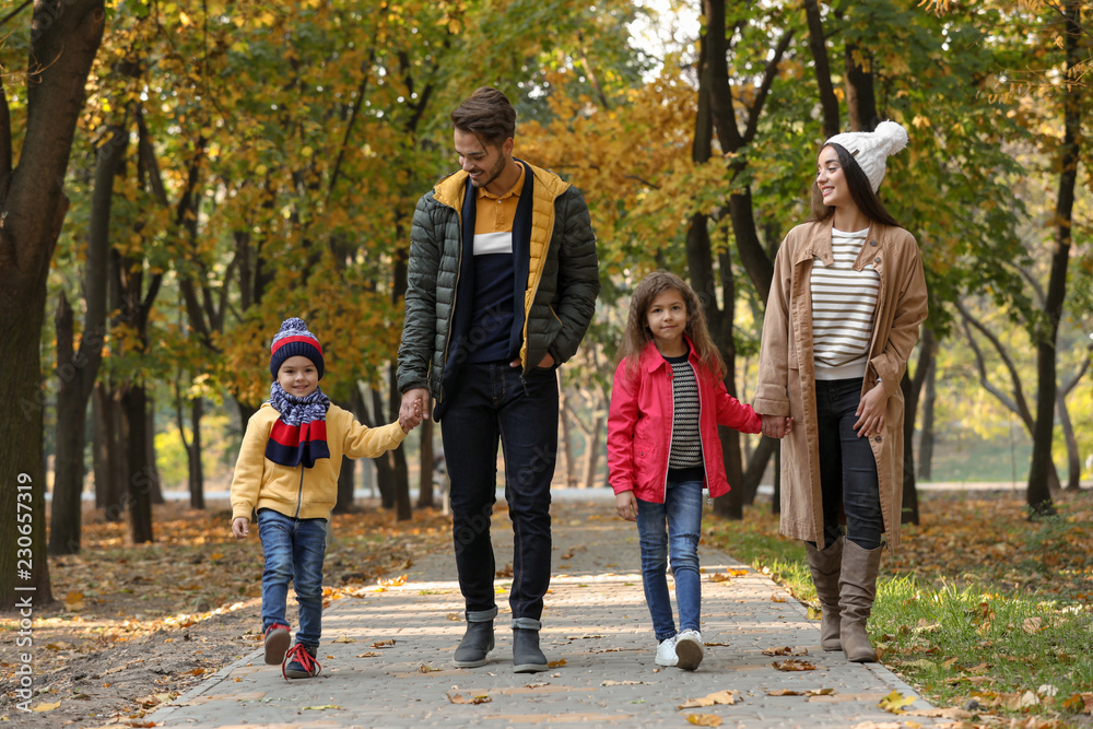 Fototapeta premium Happy family with children spending time together in park. Autumn walk