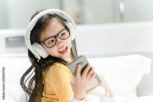 happy asian girl student listening to music with headphones
