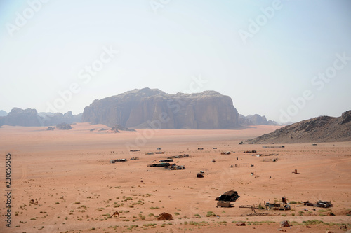 Red mountains of the canyon of Wadi Rum desert in Jordan. Wadi Rum also known as The Valley of the Moon is a valley cut into the sandstone and granite rock in southern Jordan to the east of Aqaba