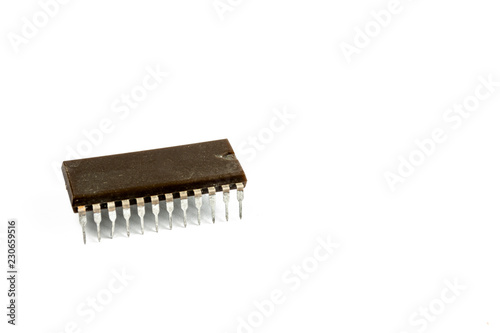 Very old computer chip isolated on a white background. © Oleg