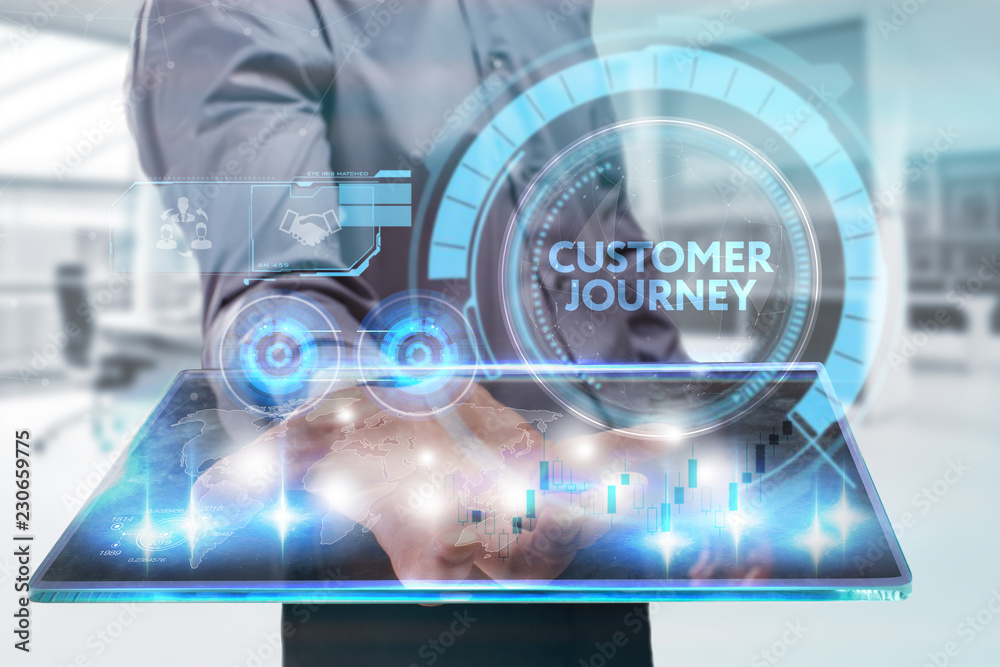 The concept of business, technology, the Internet and the network. A young entrepreneur working on a virtual screen of the future and sees the inscription: Customer journey The concept of business, technology, the Internet and the network. A young entrepreneur working on a virtual screen of the future and sees the inscription: Customer journey
