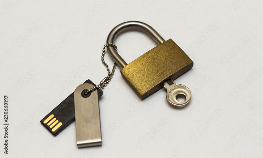 The concept of information storage. Padlock and usb flash drive. locked closed padlock with usb memory stick through it isolated on white background The concept of information storage. Padlock and usb flash drive. locked closed padlock with usb memory stick through it isolated on white background