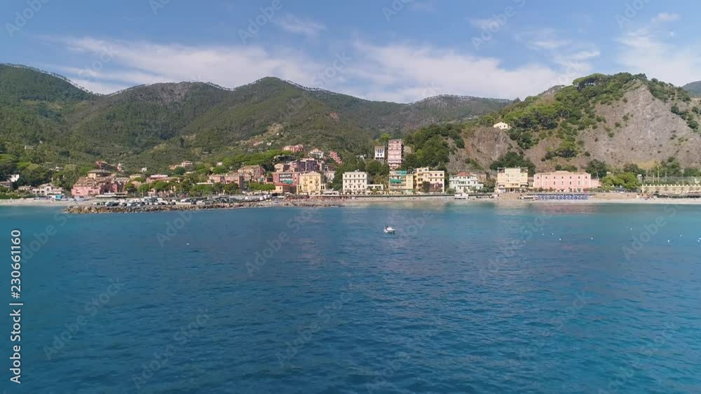 Aerial: Beautiful town village on the coast of Mediterranean sea Large mountains behind Sunny day Italy Aerial: Beautiful town village on the coast of Mediterranean sea Large mountains behind Sunny day Italy