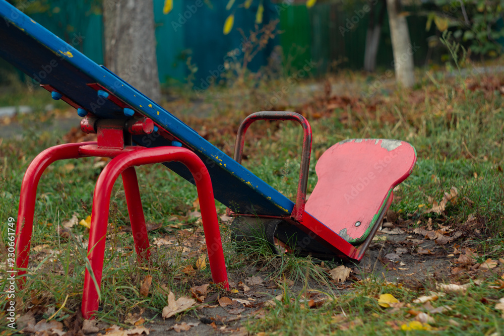 Baby swing in the fall in the park in wet weather Baby swing in the fall in the park in wet weather