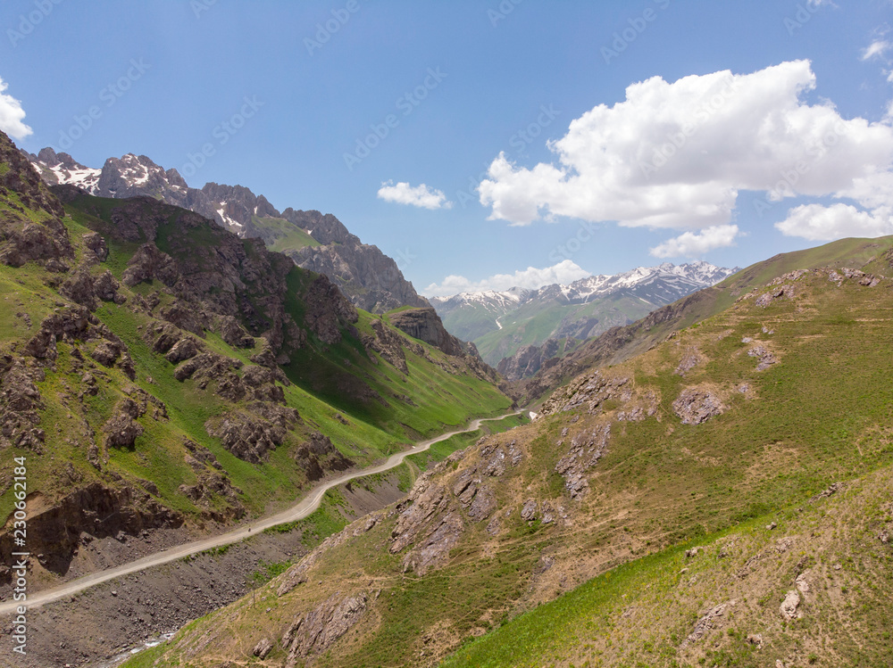 The Historical Pamir Highway Travels Through the Central Asian Nations of Afghanistan, Uzbekistan, Tajikistan, and Kyrgyzstan. Mountains Gravel Curves