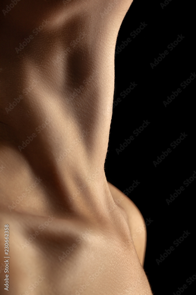 Naklejka premium beautiful female slim neck with clavicle on black background