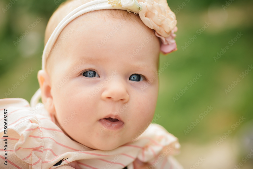 Happy little baby. Happy newborn girl. Carefree baby girl. Health and development of newborn. Early development is fundamental to the growth of your child Happy little baby. Happy newborn girl. Carefree baby girl. Health and development of newborn. Early development is fundamental to the growth of your child