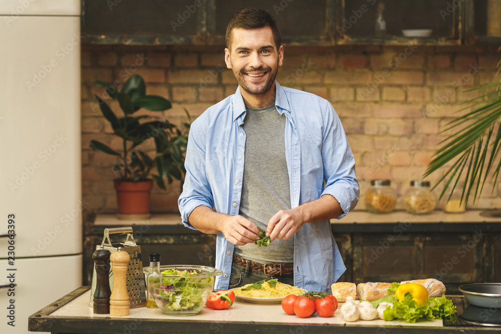 Man preparing delicious and healthy food in the home kitchen on a sunny day. Man preparing delicious and healthy food in the home kitchen on a sunny day.