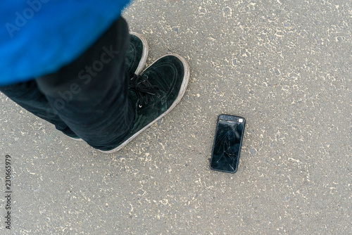 broken smartphone fall on the ground and crash in the street f