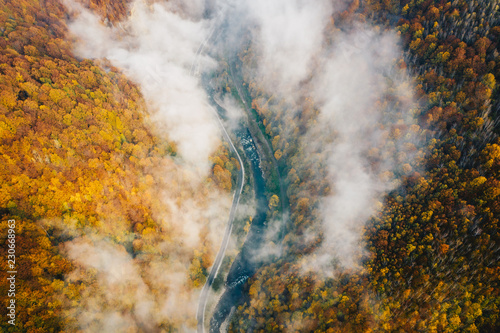 Autumn foggy road and railway aerial view