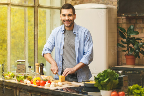 Man preparing delicious and healthy food in the home kitchen on a sunny day.