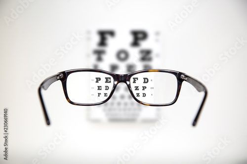 Eyeglasses during optometric examination / Exam view with optometric table and tortoise glasses photo