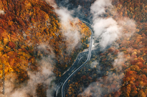 Aerial view of a canyon mountain road on a foggy morning in Jiului Valley photo