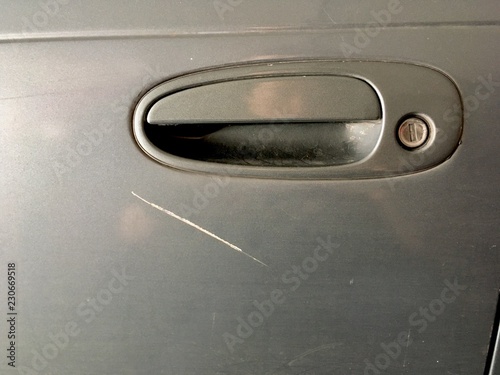 Grazed Scratch on Car - The gray car is scratched by the crashes caused by the careless driving.