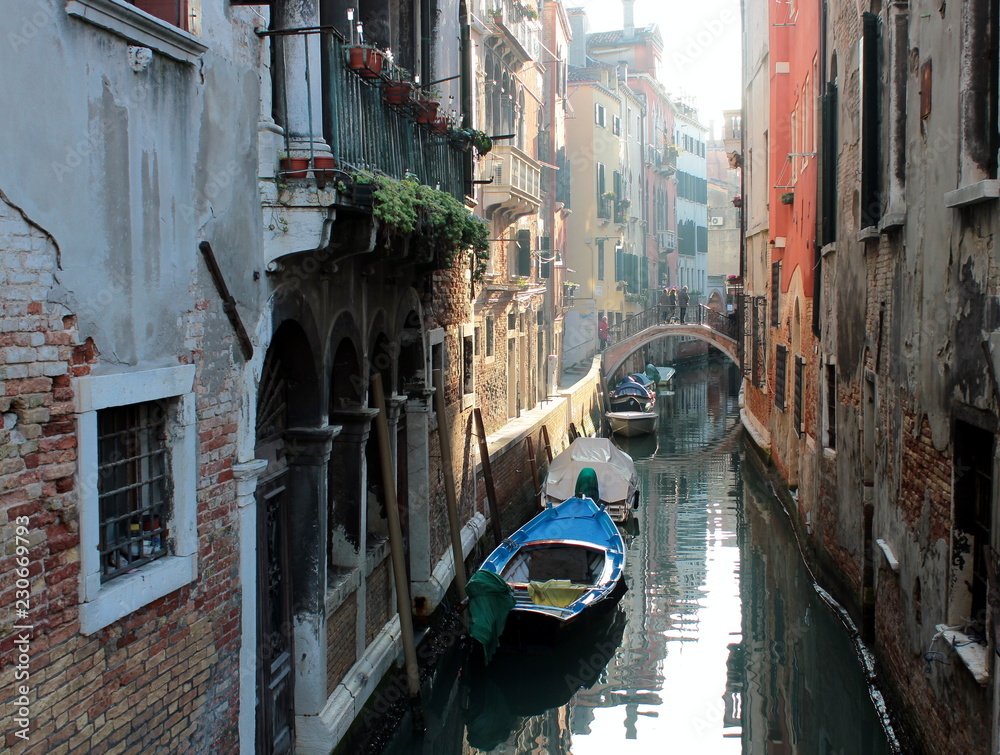 The canal in Venice. Ancient buildings, bridges, boats, reflections in the water